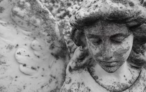 stone angel with cracked face