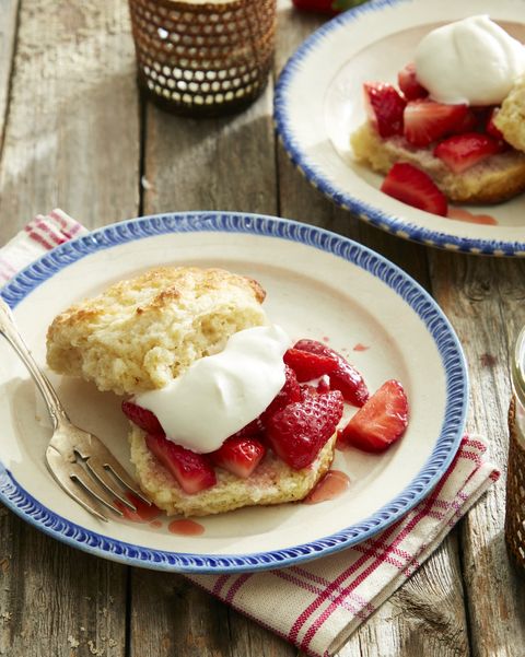 brandied strawberry shortcakes with malted whipped cream on a plate on a wooden table