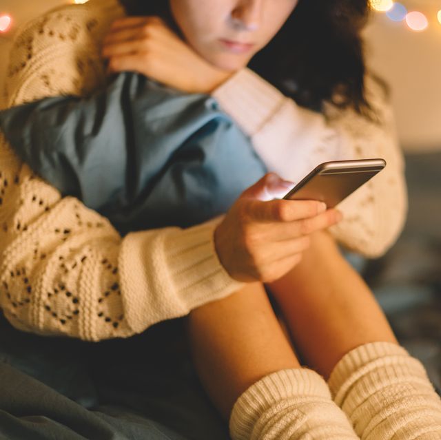 girl texting on smartphone at home