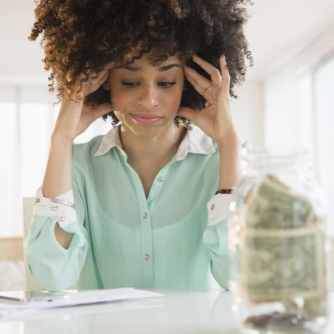 stressed mixed race woman paying bills