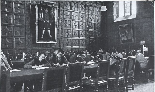 students doing an examination in trinity college, cambridge