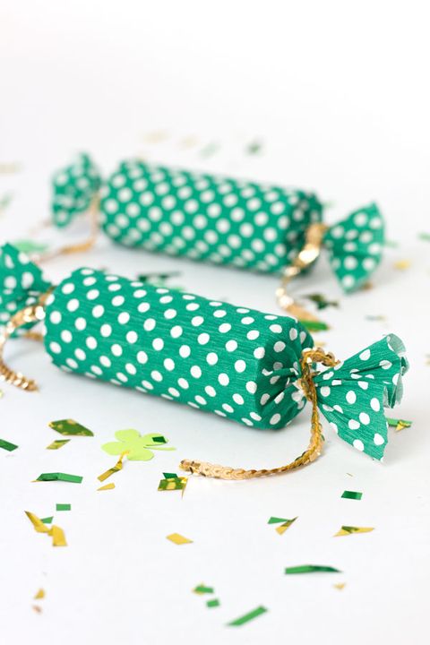 two green and white polka dot party poppers tied on the end with gold sequined cord