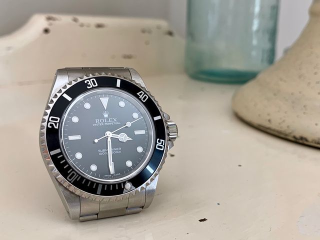 submariner watch on white table