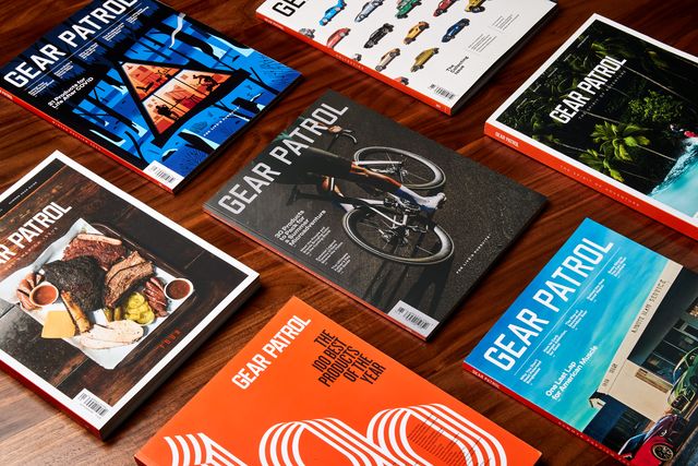 spread of gear patrol magazine copies on a wood table