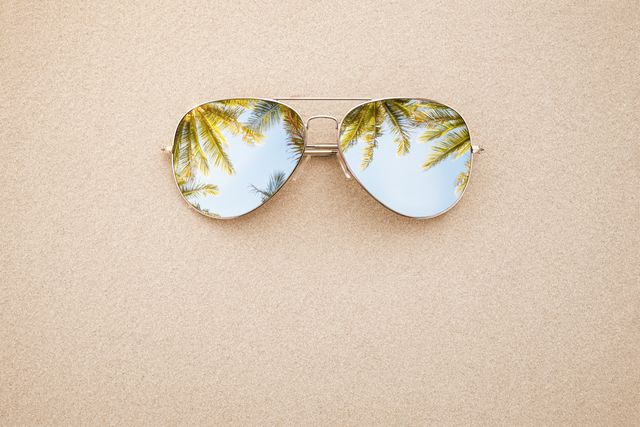 summer concept, sunglasses in the sand
