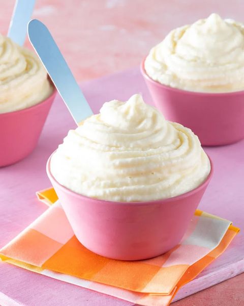 homemade dole whip in pink bowl with wooden spoon