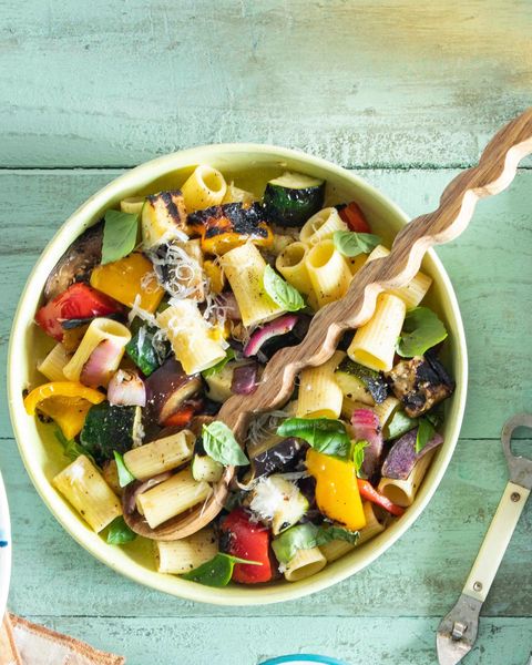 grilled ratatouille pasta salad in a bowl with a wood spoon