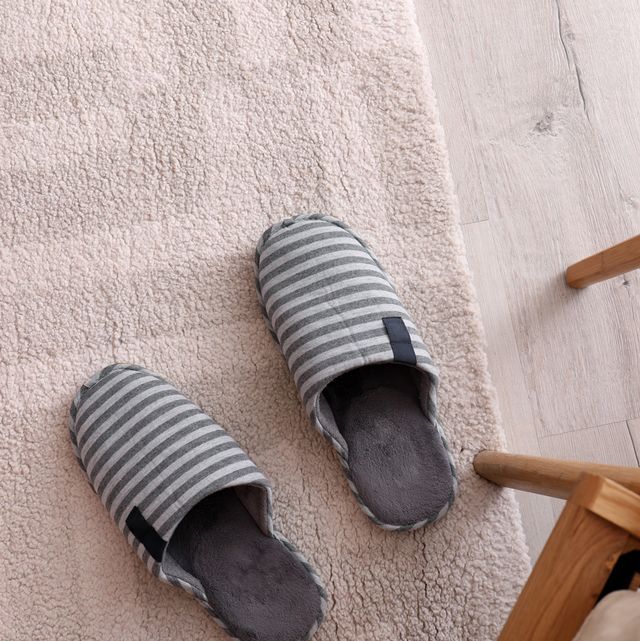 striped cotton slippers on floor next to table and chair