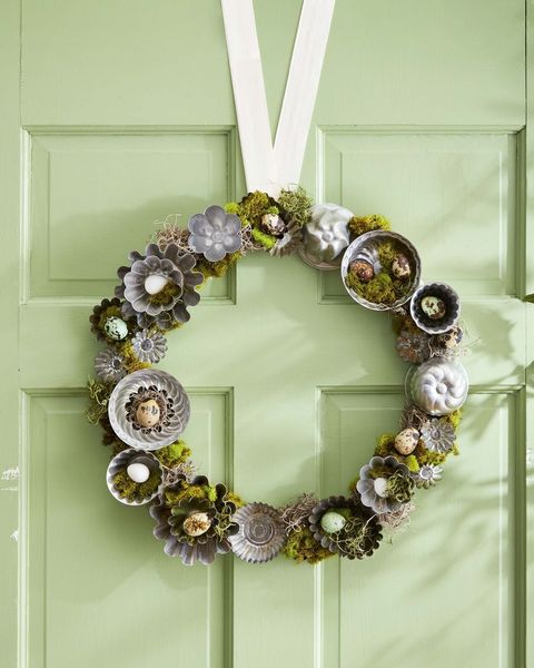 a summer wreath made from small vintage tart tins filled with green moss and robin and quail eggs