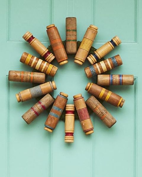 a round summer wreath made from the heads of vintage croquet mallets