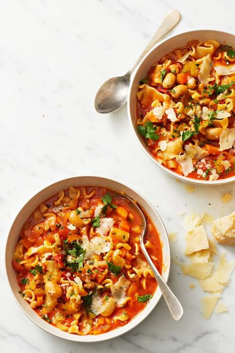 two bowls of pasta e fagioli with a red sauce