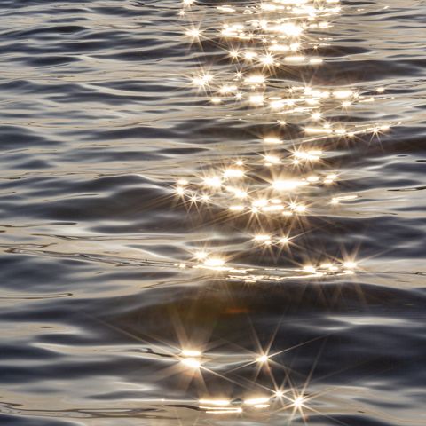 sunshine reflection on ocean wave with star shape