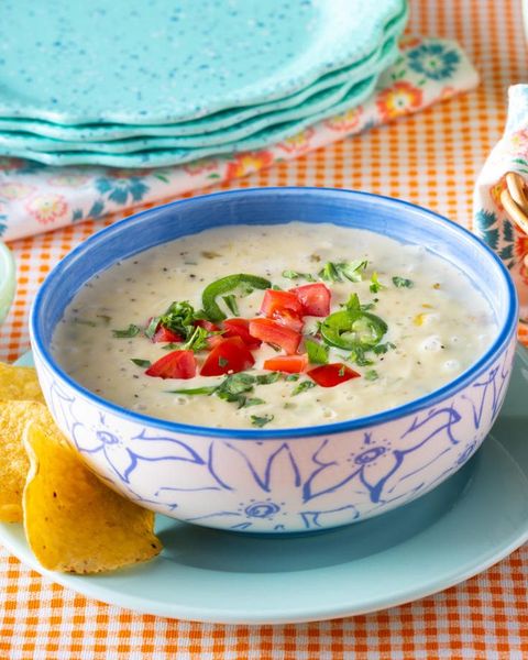 easy queso dip in blue and white bowl with chips
