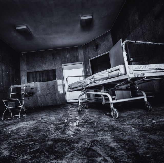 creepy abandoned hospital photo of surgery table