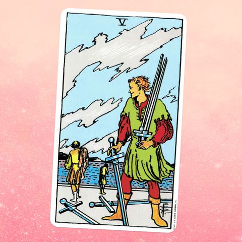 the tarot card the five of swords, showing a person carrying three swords with two others on the ground two other people can be seen in the distance in the background