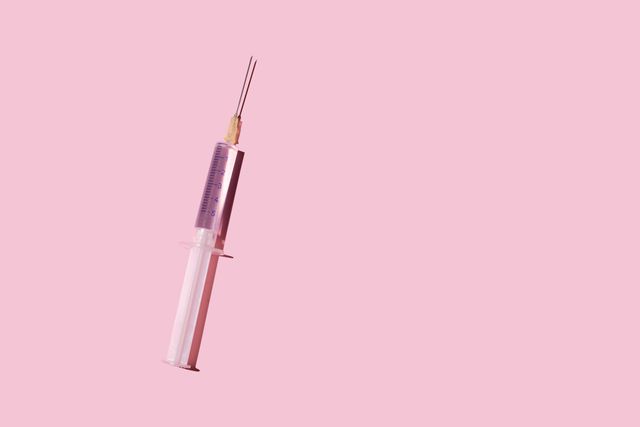syringe on the pink background