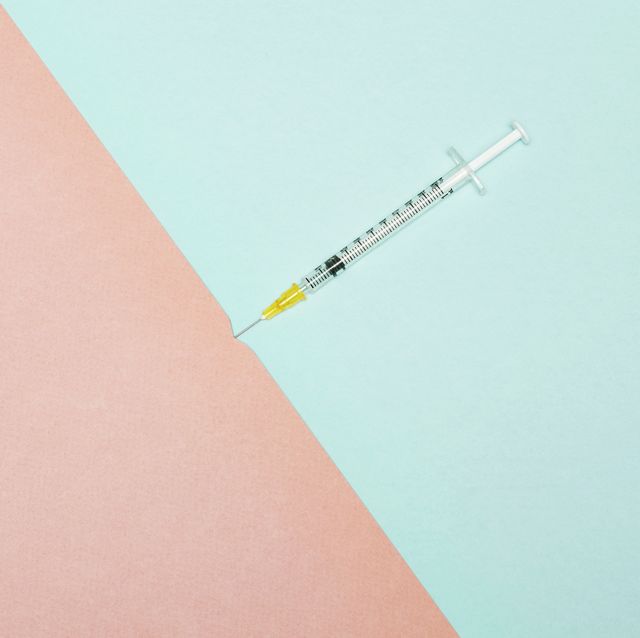 syringe piercing skin, conceptual image