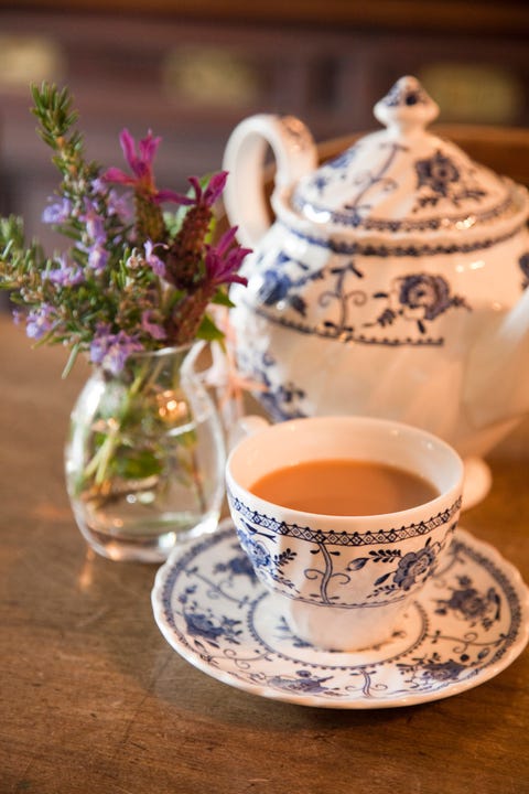 Table with traditional teapot and teacup and saucer