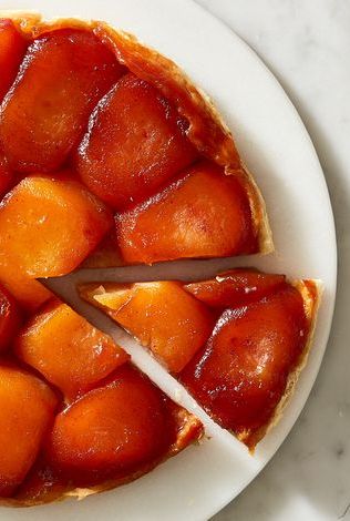 tarte tatin with a slice being pulled out