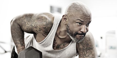 Tattooed middle aged bearded black man at a gym