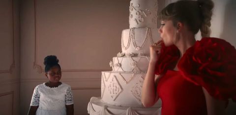 taylor swift standing next to a wedding cake in the i bet you think about me music video
