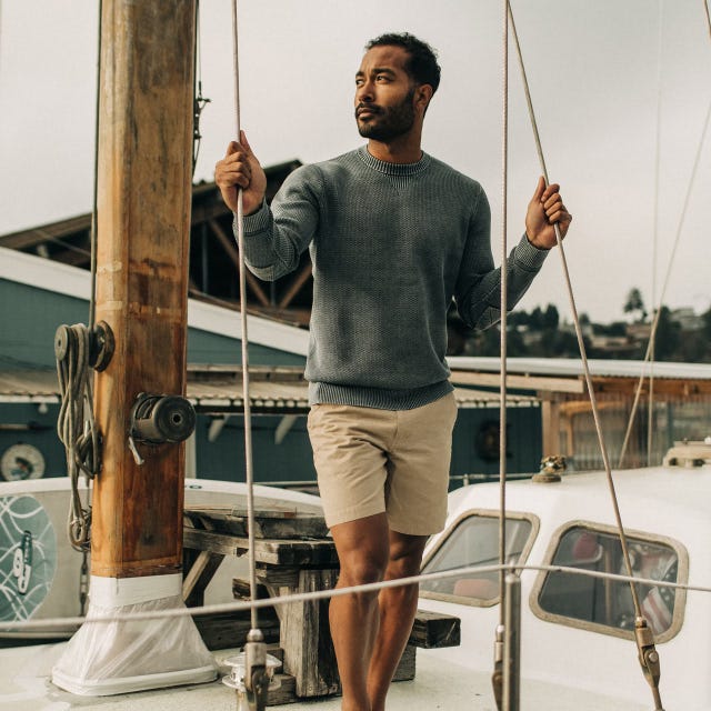 Young man standing on sailboat in sweater and Taylor Stitch The Morse Linen Short young man standing on sailboat in sweater and taylor stitch the morse linen short