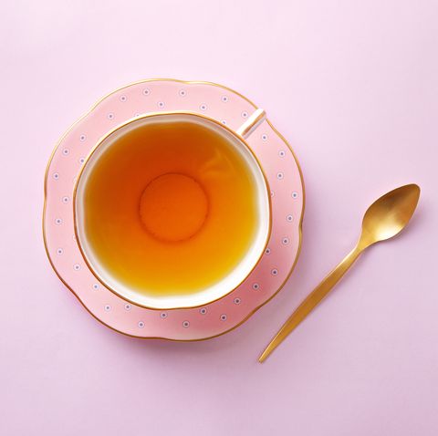 Tea cup on pastel pink background. Top view