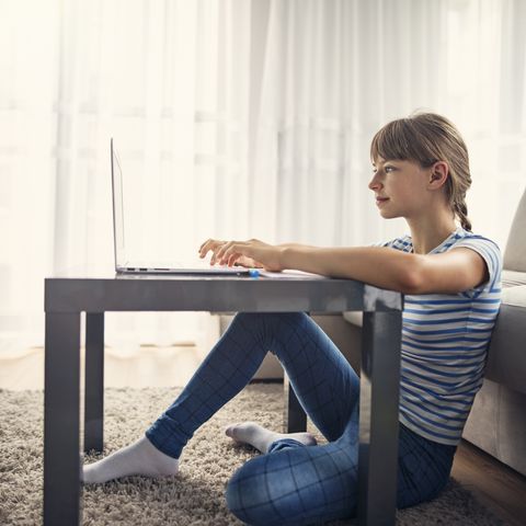 Teenage girl doing homework at home