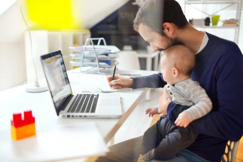 Working dad little baby boy is spending time in his dads office
