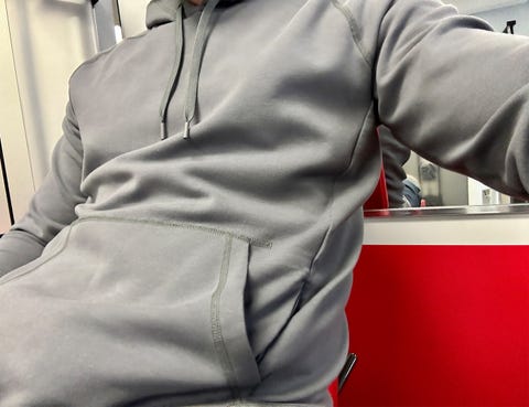 a man wearing a ten thousand midweight tech pullover hoodie