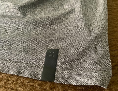 a close up shot of the bottom edge and logo of the ten thousand seamless shirt