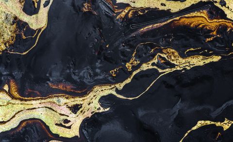 texture of crude oil spill on sand beach from oil spill accident