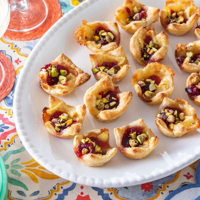 thanksgiving appetizers cranberry brie bites on white platter