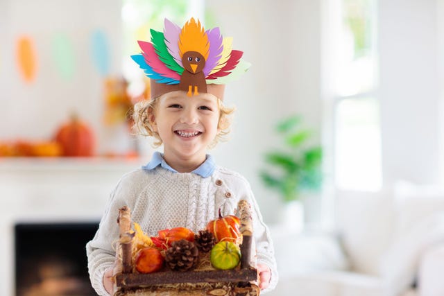 child wearing a turkey headband