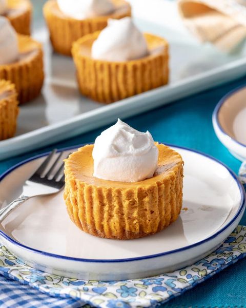 mini pumpkin cheesecakes on white and blue plate