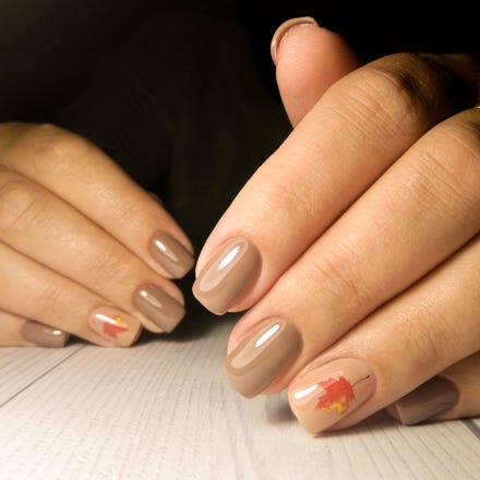 thanksgiving nails neutral brown autumn gel varnish neat manicure of womens nails with maple leaf design orange maple leaf pattern