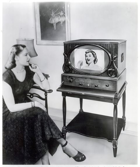 woman sits and watches television in ad