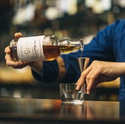someone pouring the balvenie twenty five scotch whiskey