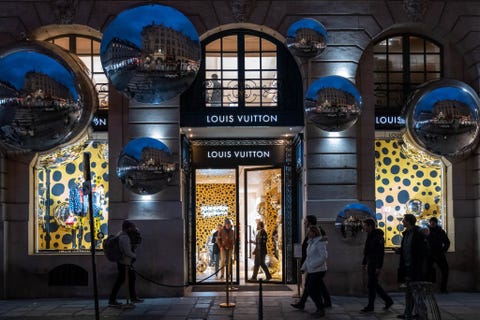 the facade of the louis vuitton store displays a yayoi kusama robot and mirrors at place vendome