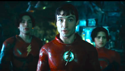 ezra miller wearing red superhero costume with lightning bolt logo in the flash