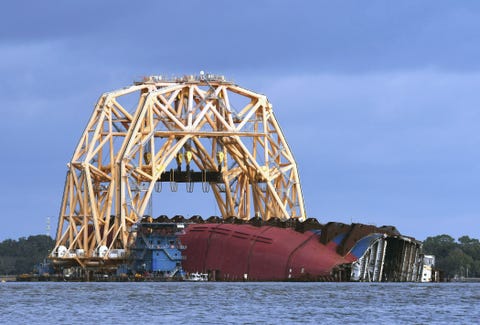 The Golden Ray cargo ship lies on its side in the water... the golden ray cargo ship lies on its side in the water