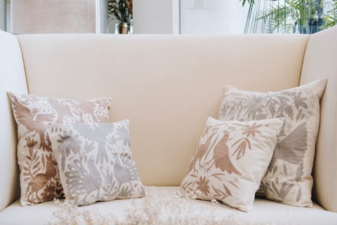 alexa topote's neutral colored pillow creations for her company, by hand mexico, boast otomi embroidery