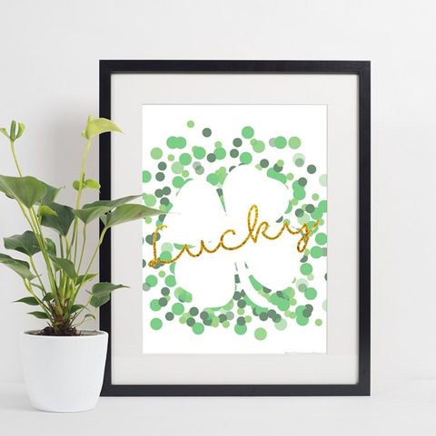 framed printable with a white shamrock outlined by green dots with lucky in gold written across it