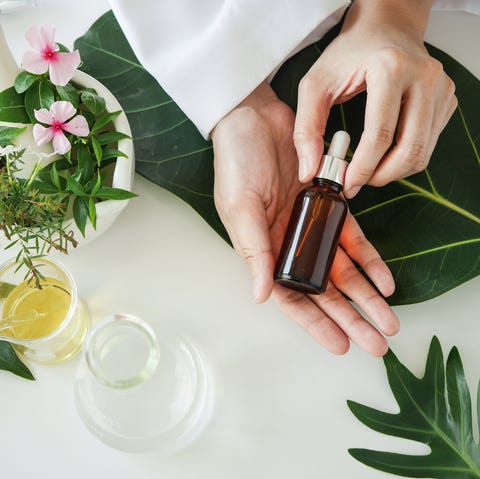 the scientist,dermatologist with the organic natural product in the laboratory.research and development beauty skincare concept.blank package,bottle,container .cream,serum.hand