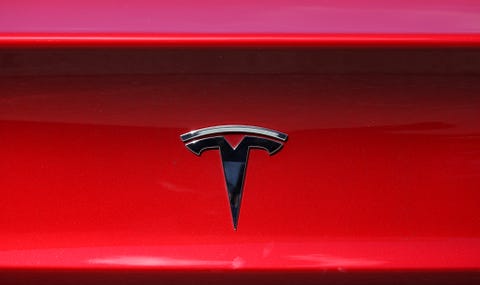 tesla reports quarterly earnings