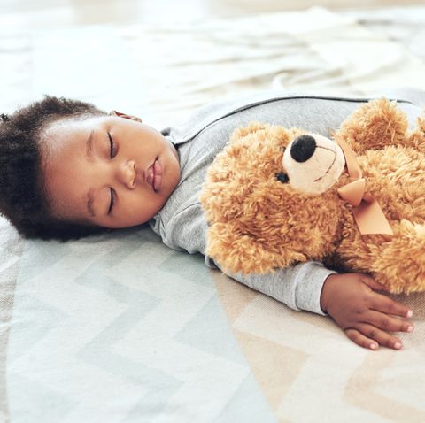 a sleeping baby boy with a teddy, used in a story about middle names for boys