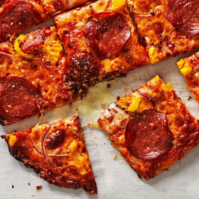thin crust pizza with pepperoni, onions and banana peppers