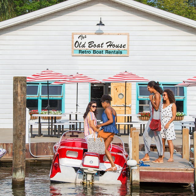 group of women boarding red speedboat at retro boat rentals in saugatuck michigan