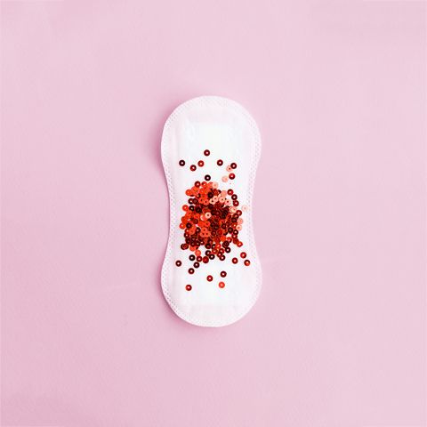 menstrual pad with red glitter on pastel background