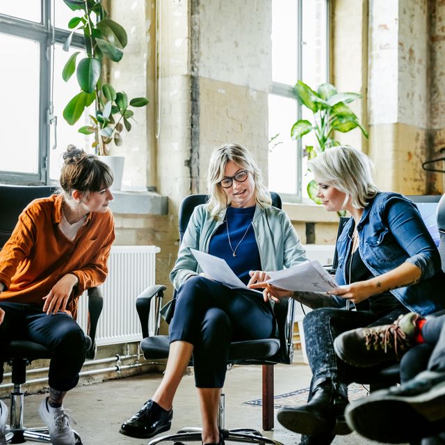 three casual businesswomen discussing during meeting